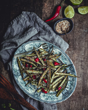 roast okra on a blue plate